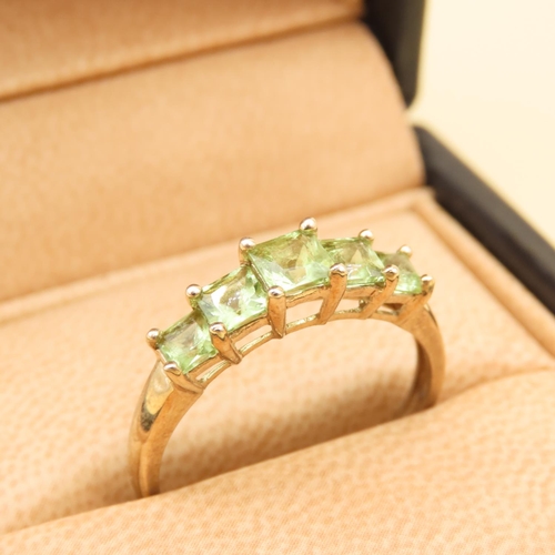 74 - Five Stone Princess Cut Peridot Ring Mounted on 9 Carat Yellow Gold Band Ring Size V and a Half