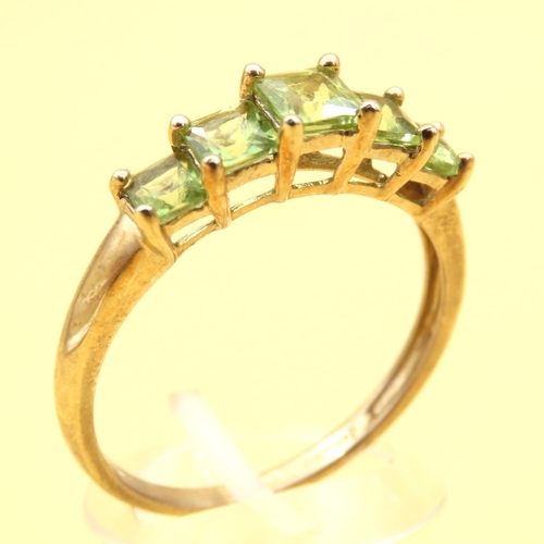 74 - Five Stone Princess Cut Peridot Ring Mounted on 9 Carat Yellow Gold Band Ring Size V and a Half
