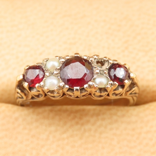 84 - Three Stone Red Garnet and Seed Pearl Ring Mounted on 9 Carat Yellow Gold Band Size P