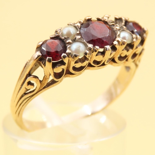 84 - Three Stone Red Garnet and Seed Pearl Ring Mounted on 9 Carat Yellow Gold Band Size P