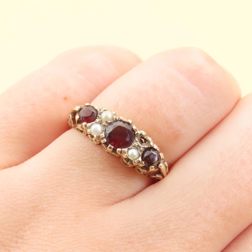 84 - Three Stone Red Garnet and Seed Pearl Ring Mounted on 9 Carat Yellow Gold Band Size P