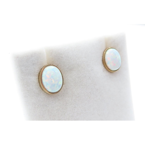 1086 - Pair of Opal set Earrings Mounted in 9 Carat Yellow Gold