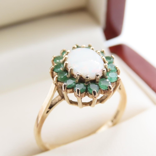 1111 - Opal and Emerald Ladies Cluster Ring Mounted on 9 Carat Yellow Gold Ring Size O