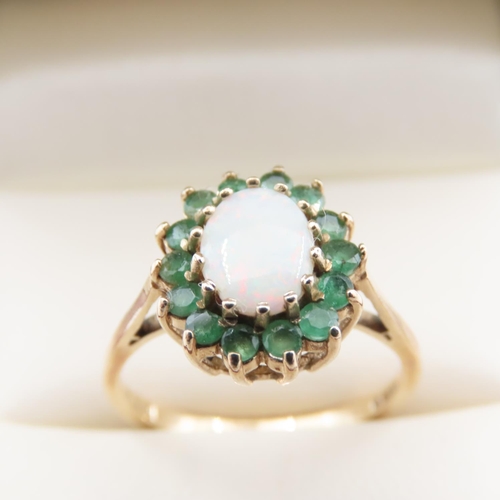 1111 - Opal and Emerald Ladies Cluster Ring Mounted on 9 Carat Yellow Gold Ring Size O