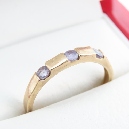 1253 - Three Stone Amethyst Ring set in 9 Carat Yellow Gold Band Ring Size T and a Half