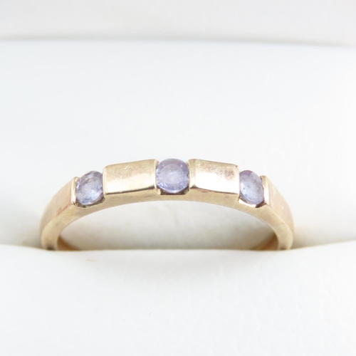 1253 - Three Stone Amethyst Ring set in 9 Carat Yellow Gold Band Ring Size T and a Half