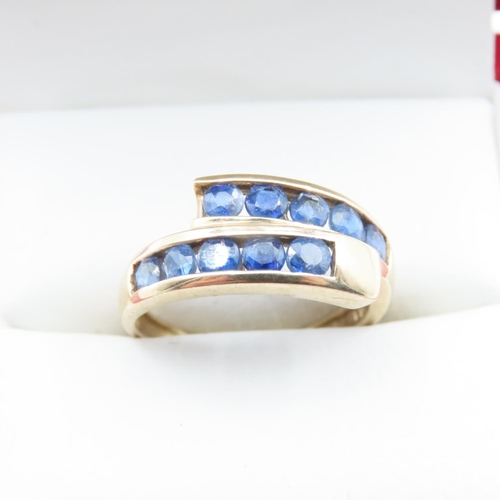 1363 - Ten Stone Sapphire Set 9 Carat Yellow Gold Wrap Around Motif Ring Size O