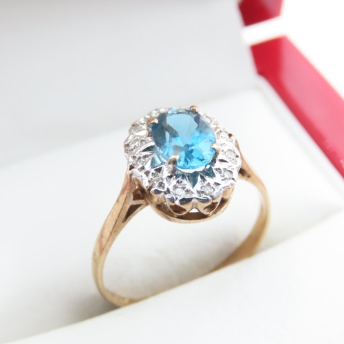 1368 - Blue Topaz and Diamond Ladies Cluster Ring Mounted in 9 Carat Yellow Gold Ring Size N and a Half