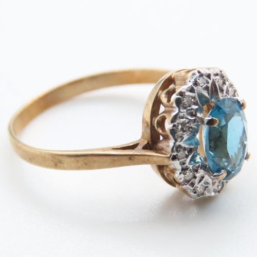 1368 - Blue Topaz and Diamond Ladies Cluster Ring Mounted in 9 Carat Yellow Gold Ring Size N and a Half