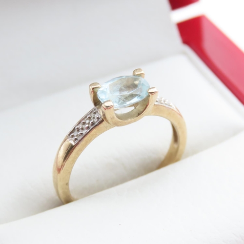 1372 - Aquamarine Solitaire Ring with Further Diamonds Set to Shoulder Mounted in 9 Carat Yellow Gold Ring ... 