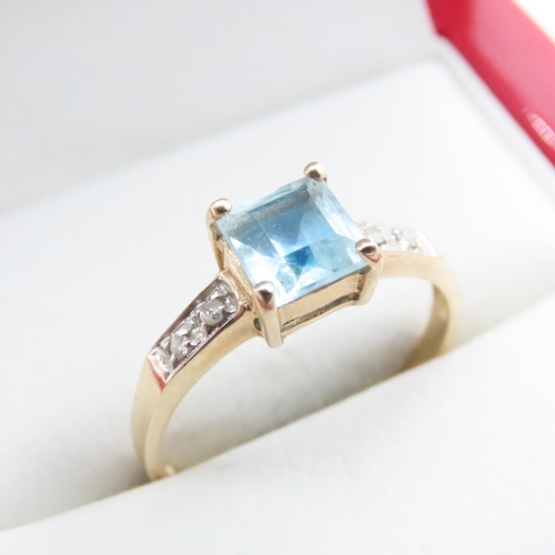 1635 - Princess Cut Blue Topaz Ring with Further Diamonds Set to Shoulder Mounted in 9 Carat Yellow Gold Ri... 