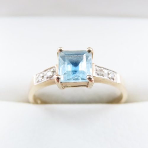 1635 - Princess Cut Blue Topaz Ring with Further Diamonds Set to Shoulder Mounted in 9 Carat Yellow Gold Ri... 