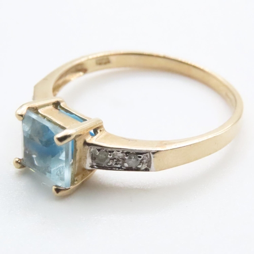 1635 - Princess Cut Blue Topaz Ring with Further Diamonds Set to Shoulder Mounted in 9 Carat Yellow Gold Ri... 