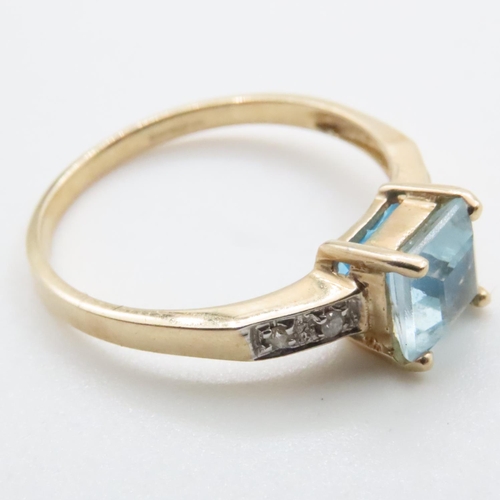 1635 - Princess Cut Blue Topaz Ring with Further Diamonds Set to Shoulder Mounted in 9 Carat Yellow Gold Ri... 