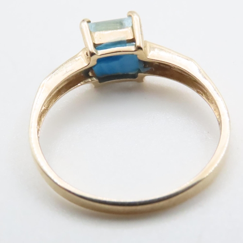 1635 - Princess Cut Blue Topaz Ring with Further Diamonds Set to Shoulder Mounted in 9 Carat Yellow Gold Ri... 