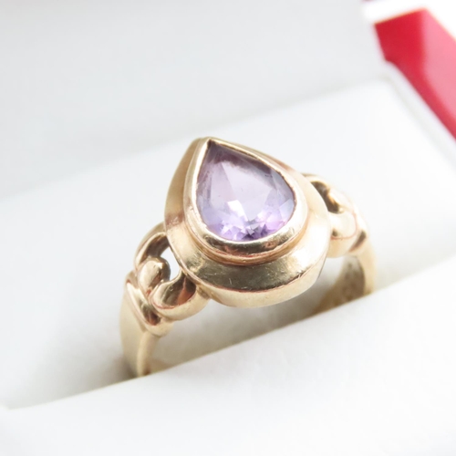 1705 - Pear Cut Bezel Set Amethyst Ring Mounted on 9 Carat Yellow Gold Band Ring Size L