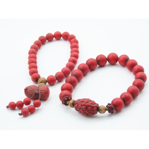 397 - Two Carved Red Coral Bead Bracelets