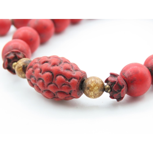 397 - Two Carved Red Coral Bead Bracelets