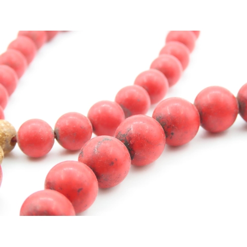 397 - Two Carved Red Coral Bead Bracelets