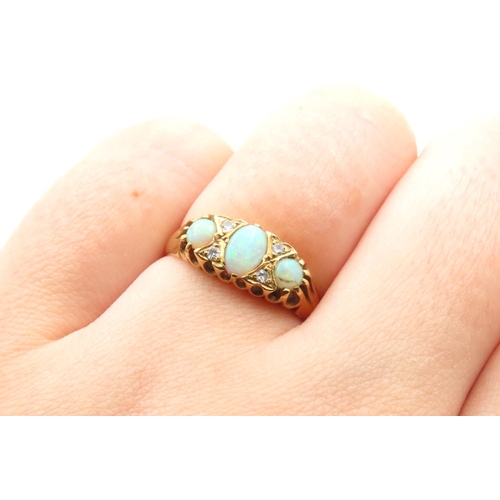 234 - Three Stone Opal and Diamond Rind Mounted on 18 Carat Yellow Gold Band Size M