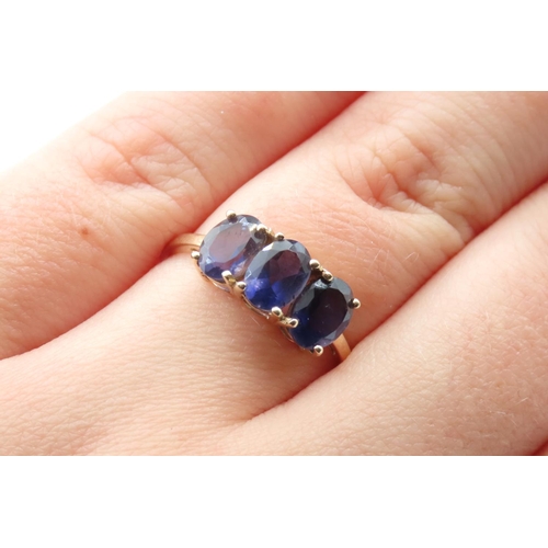 33 - Three Stone Iolite Ring Set in 10 Carat Yellow Gold Ring Size Q