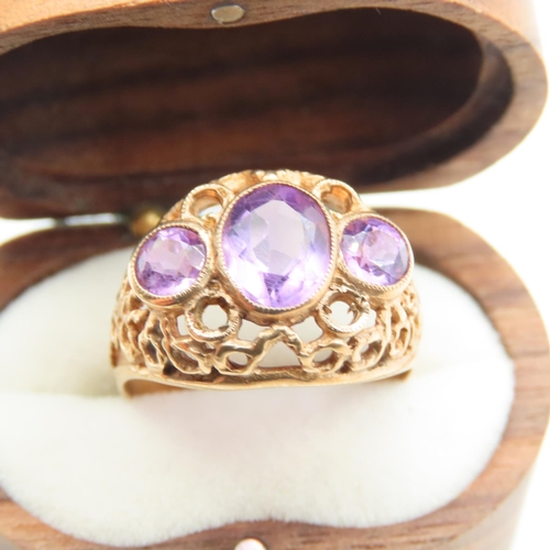 516 - Three Stone Amethyst Ladies Ring Mounted on 9 Carat Yellow Gold Openwork Scroll Setting Ring Size O