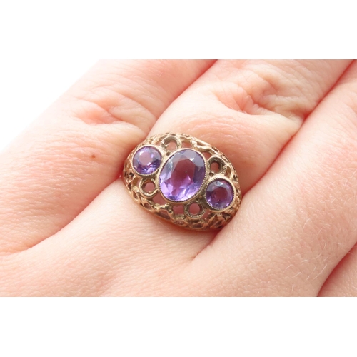 516 - Three Stone Amethyst Ladies Ring Mounted on 9 Carat Yellow Gold Openwork Scroll Setting Ring Size O