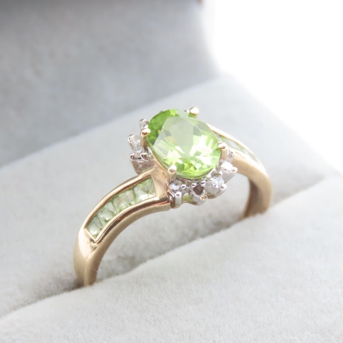Peridot and Diamond Set Ladies Cluster Ring with Further Peridot Set to Shoulders Mounted in 9 Carat Yellow Gold Ring Size Q