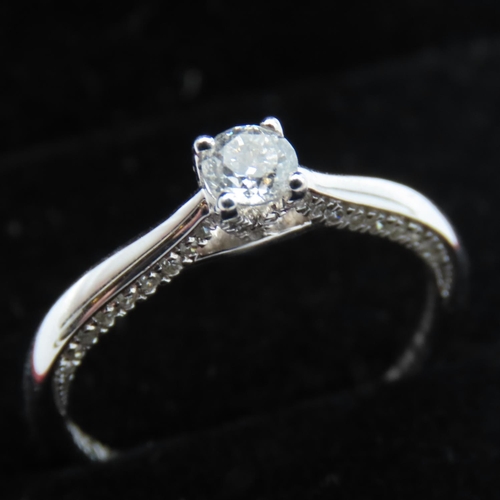 Forever Diamond Solitaire Ring Mounted on 18 Carat White Gold Band Ring Size M with Original Box and Papers Certificate Included .24 Carat E Colour Centre Stone with Further Diamond Decorated Shoulders