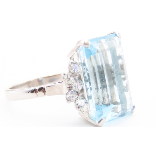 131 - Emerald Cut 12ct Aquamarine Statement Ring with Further Diamond Decoration to Shoulders Mounted on 1... 