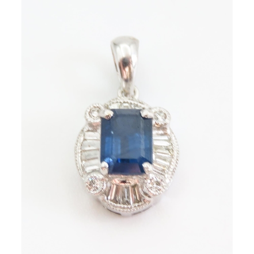 177 - Emerald Cut Sapphire Pendant with Tempered Baguette Diamond Surround Mounted in 18 Carat White Gold ... 