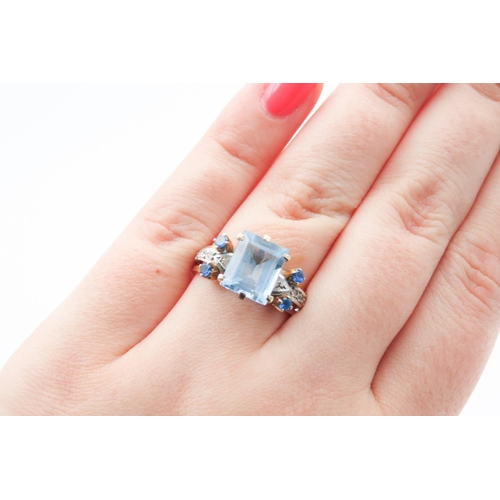 292 - Emerald Cut Aquamarine and Gemstone Set Ring Mounted in 18 Carat Yellow Gold Ring Size Q