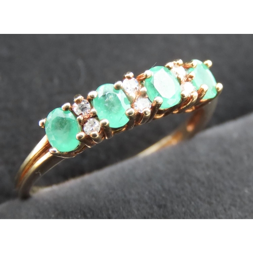 293 - Four Stone Emerald and Six Diamond Set Ring Mounted in 9 Carat Yellow Gold Ring Size Q and a Half