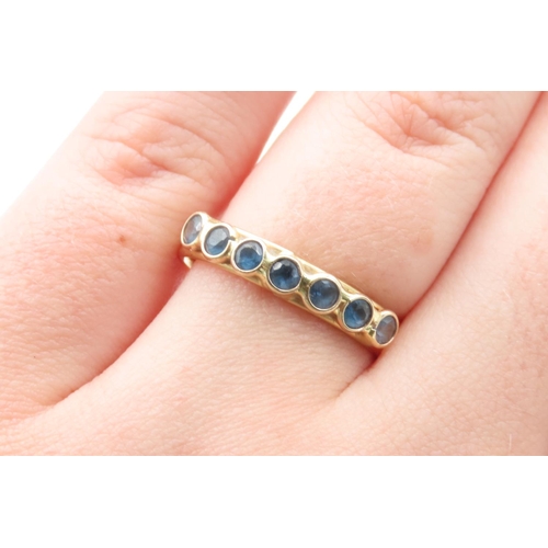 439 - Seven Stone Bezel Set Sapphire Ring Mounted in 18 Carat Yellow Gold Ring Size R