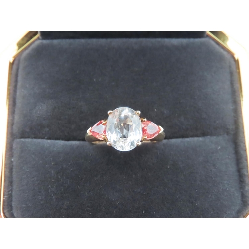 73 - Aquamarine and Garnet Three Stone Ring Mounted in 9 Carat Yellow Gold Ring Size N and a Half