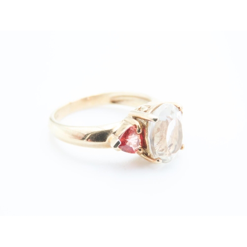 73 - Aquamarine and Garnet Three Stone Ring Mounted in 9 Carat Yellow Gold Ring Size N and a Half