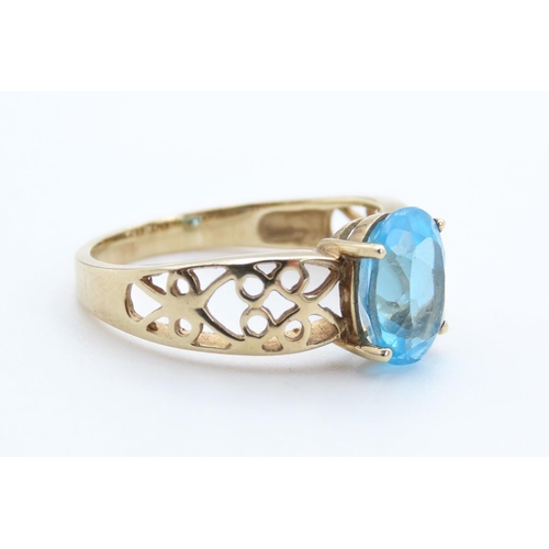 13 - Oval Cut London Blue Topaz Set Ring Mounted in 9 Carat Yellow Gold with Celtic Scroll Motif Decorati... 