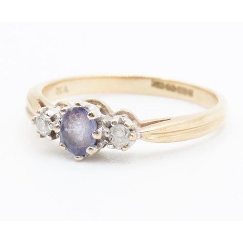 245 - Pale Tanzanite and Diamond Set Three Stone Ring Mounted in 9 Carat Yellow Gold Ring Size Q