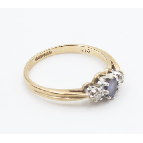 245 - Pale Tanzanite and Diamond Set Three Stone Ring Mounted in 9 Carat Yellow Gold Ring Size Q