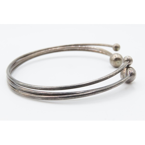 32 - Four Silver Bangles Includes One Cuff Bracelet