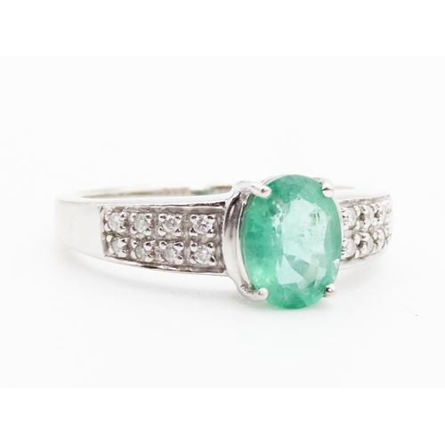 79 - Emerald Centre Stone  Four Claw Set Oval Cut Ring Set in 18 Carat White Gold with Further Diamonds S... 