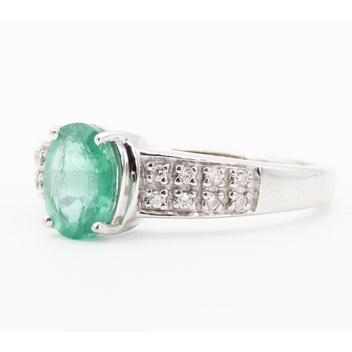 79 - Emerald Centre Stone  Four Claw Set Oval Cut Ring Set in 18 Carat White Gold with Further Diamonds S... 