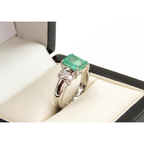 11 - Four Claw Set Emerald Ring Mounted in Platinum with Three Further Diamonds Set to Each Side Emerald ... 