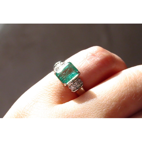 11 - Four Claw Set Emerald Ring Mounted in Platinum with Three Further Diamonds Set to Each Side Emerald ... 