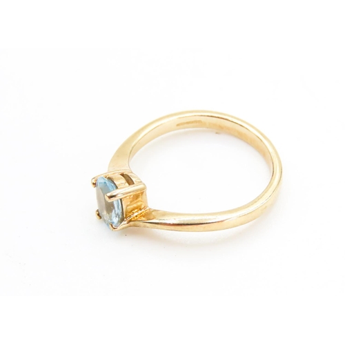 29 - Four Claw Set Aquamarine Single Stone Ring Wrap Around Form Set in 9 Carat Yellow Gold Ring Size N