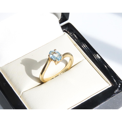 29 - Four Claw Set Aquamarine Single Stone Ring Wrap Around Form Set in 9 Carat Yellow Gold Ring Size N