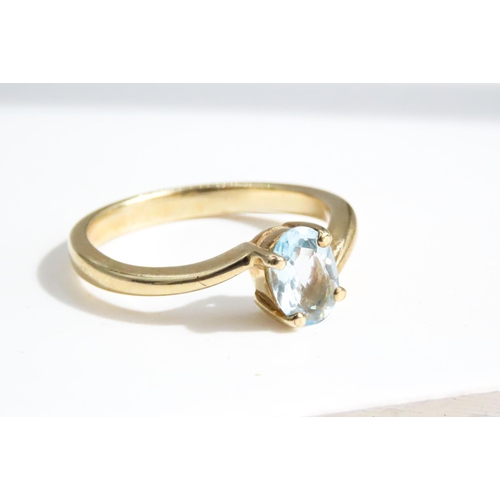 29 - Four Claw Set Aquamarine Single Stone Ring Wrap Around Form Set in 9 Carat Yellow Gold Ring Size N