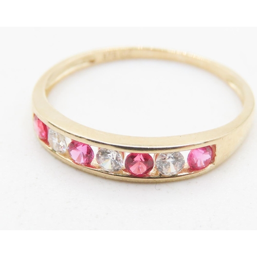 725 - Pink and Clear Gemstone Set Half Eternity Ring Mounted in 9 Carat Yellow Gold Ring Size M