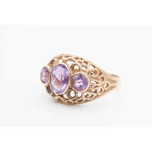 74 - Three Stone Amethyst Ladies Ring Mounted on 9 Carat Yellow Gold Openwork Scroll Setting Ring Size O