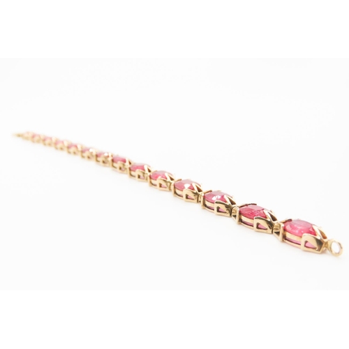 140 - Fourteen Stone Ruby Set Ladies Bracelet Attractively Detailed Mounted in 9 Carat Yellow Gold 19.5cm ... 